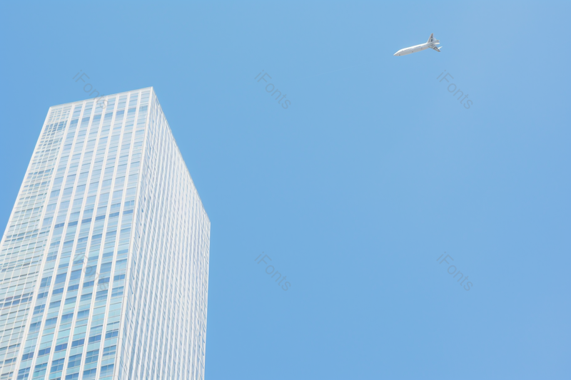 商务大厦上空掠过飞机摄影图,高清,摄影图,摄影图片,图片大全,摄影图免费下载